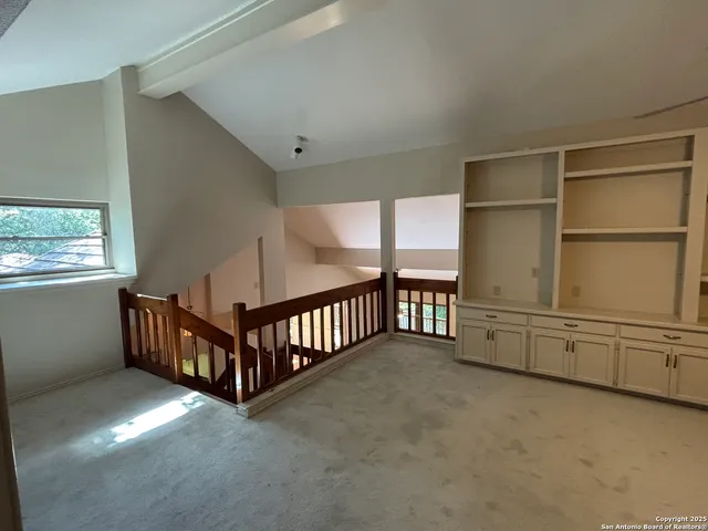 a view of an empty room with windows