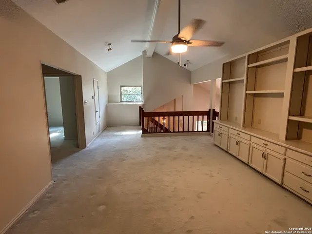 a view of a livingroom with furniture and chandelier fan