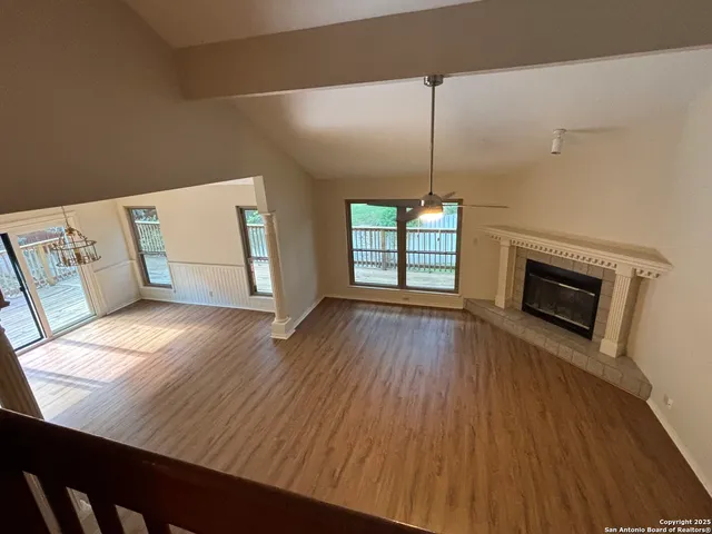 a view of a livingroom with wooden floor and fireplace
