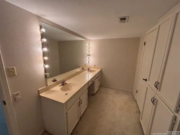 a bathroom with a sink vanity and mirror
