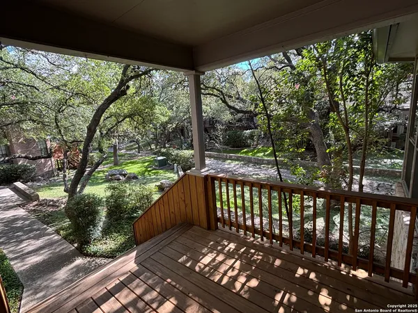 a view of a wooden deck with a yard