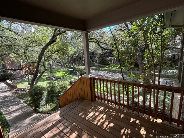 a view of a wooden deck with a yard