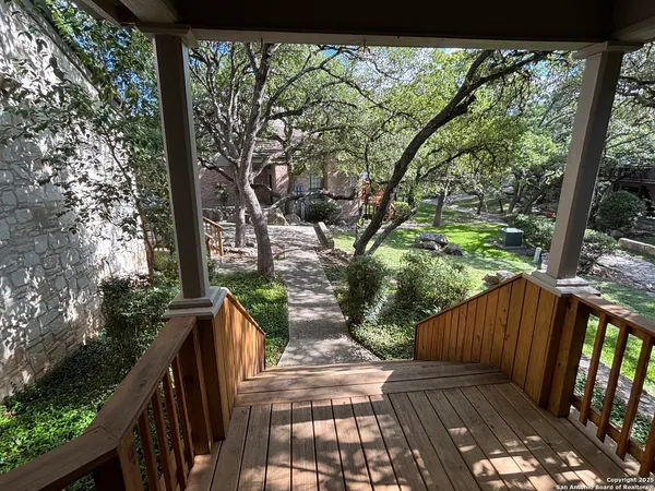 a view of balcony with wooden floor and fence