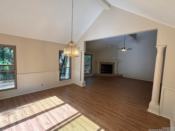 a view of empty room with wooden floor and fireplace