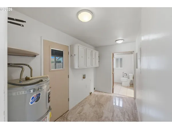 a open hall with cabinet and mirror