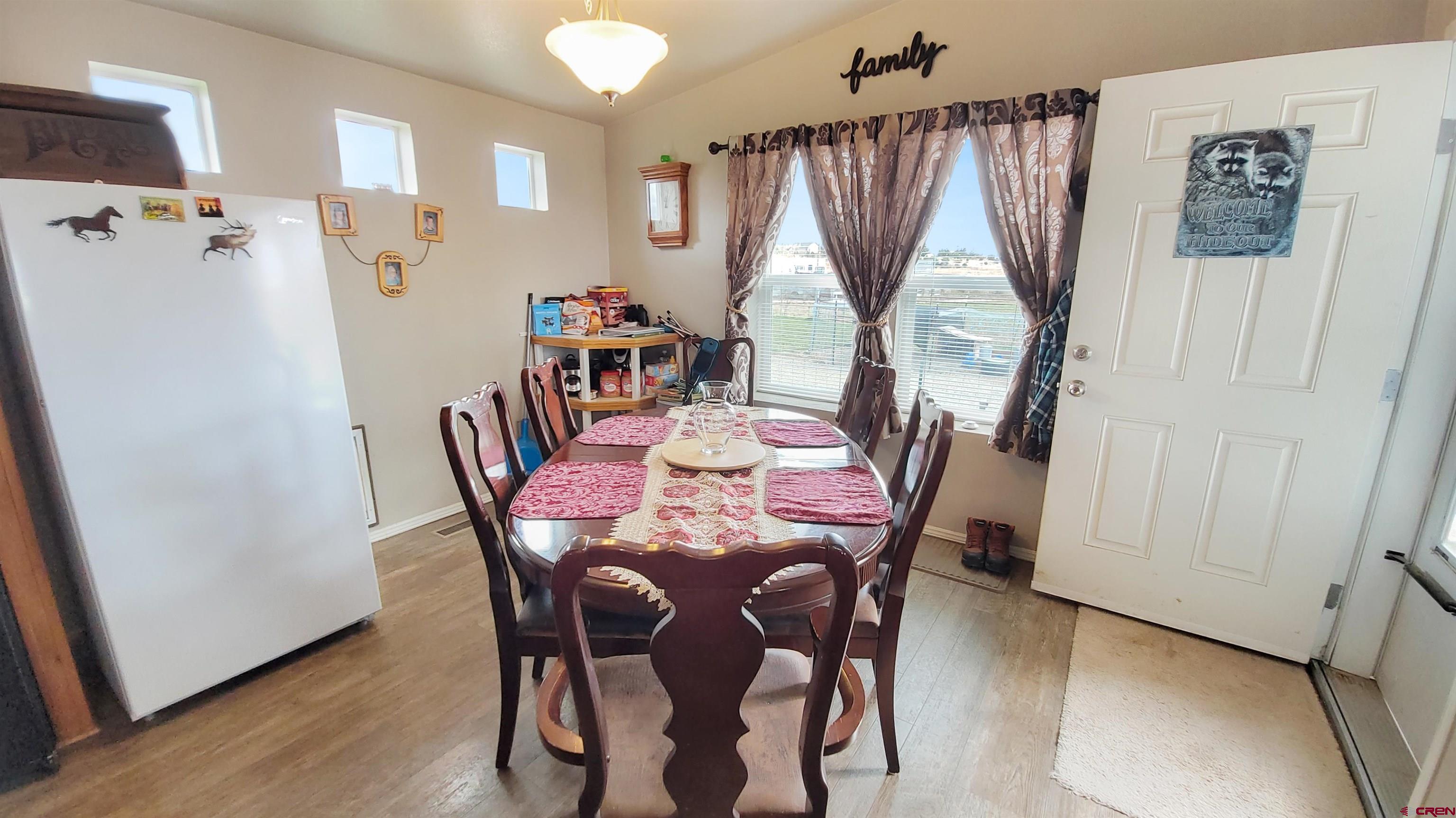 13635 County Road 23 Cortez, CO 81321 - Photo 13 of 30 a view of a dining room with furniture window and wooden floor