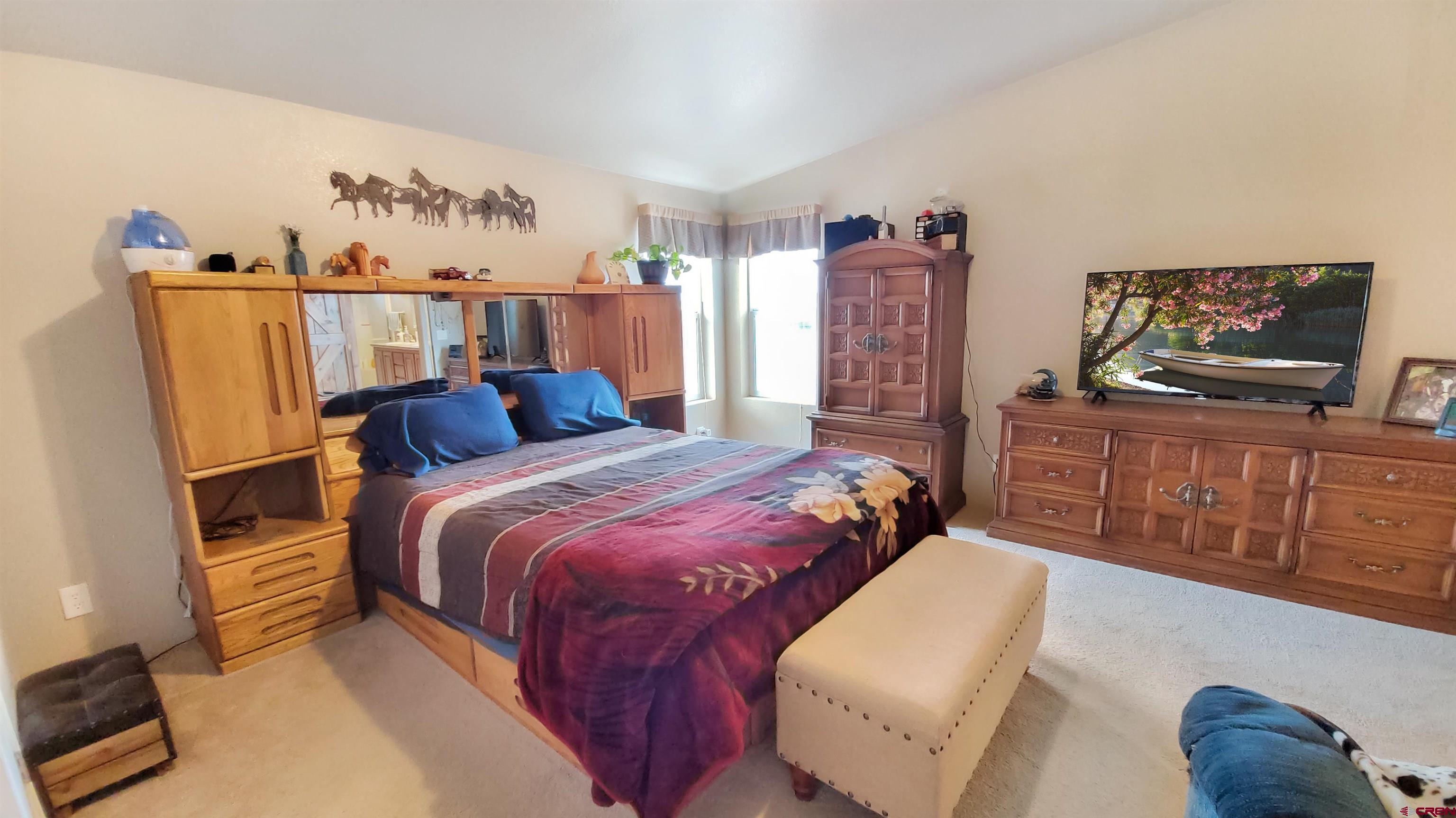 13635 County Road 23 Cortez, CO 81321 - Photo 15 of 30 a bedroom with a bed window and dresser