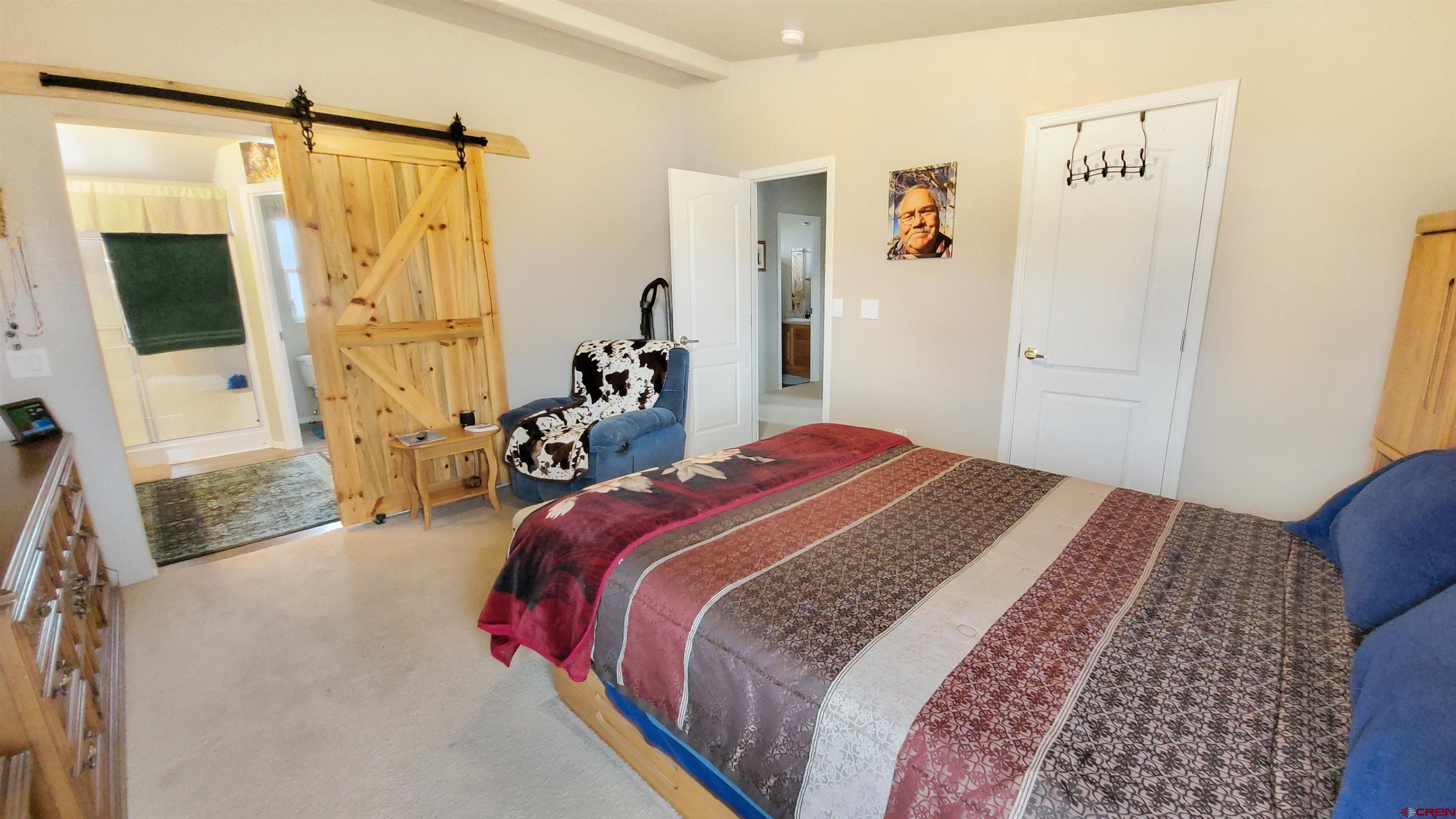 13635 County Road 23 Cortez, CO 81321 - Photo 16 of 30 a bedroom with a bed and a couch