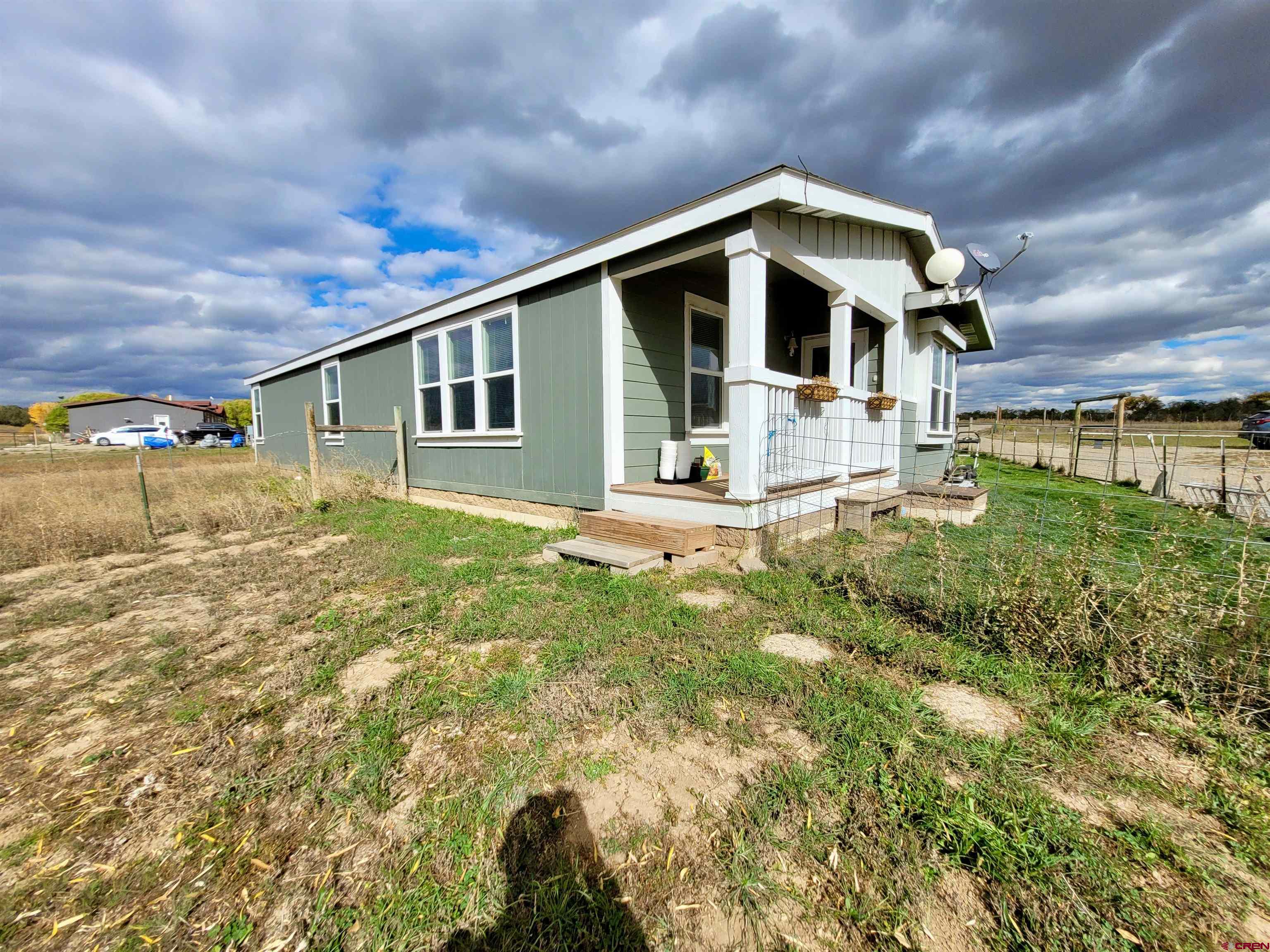 13635 County Road 23 Cortez, CO 81321 - Photo 2 of 30 a front view of a house with garden