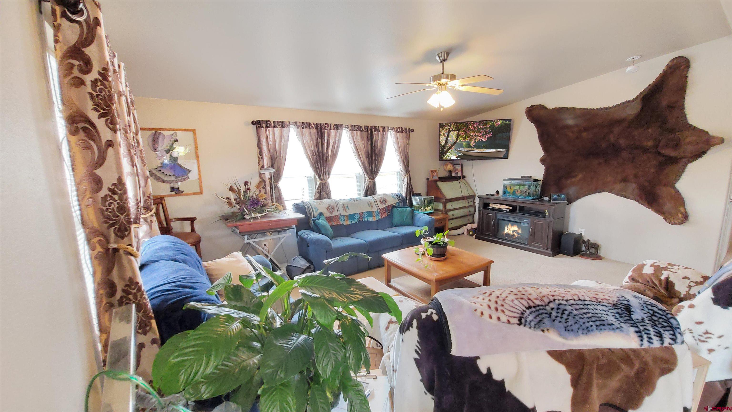 13635 County Road 23 Cortez, CO 81321 - Photo 8 of 30 a living room with furniture and a chandelier