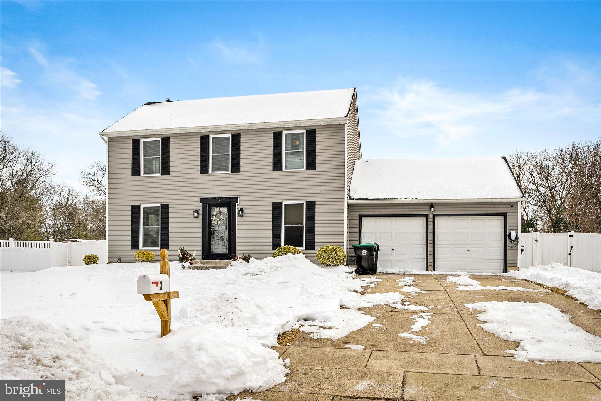 a view of a house with snow on a road