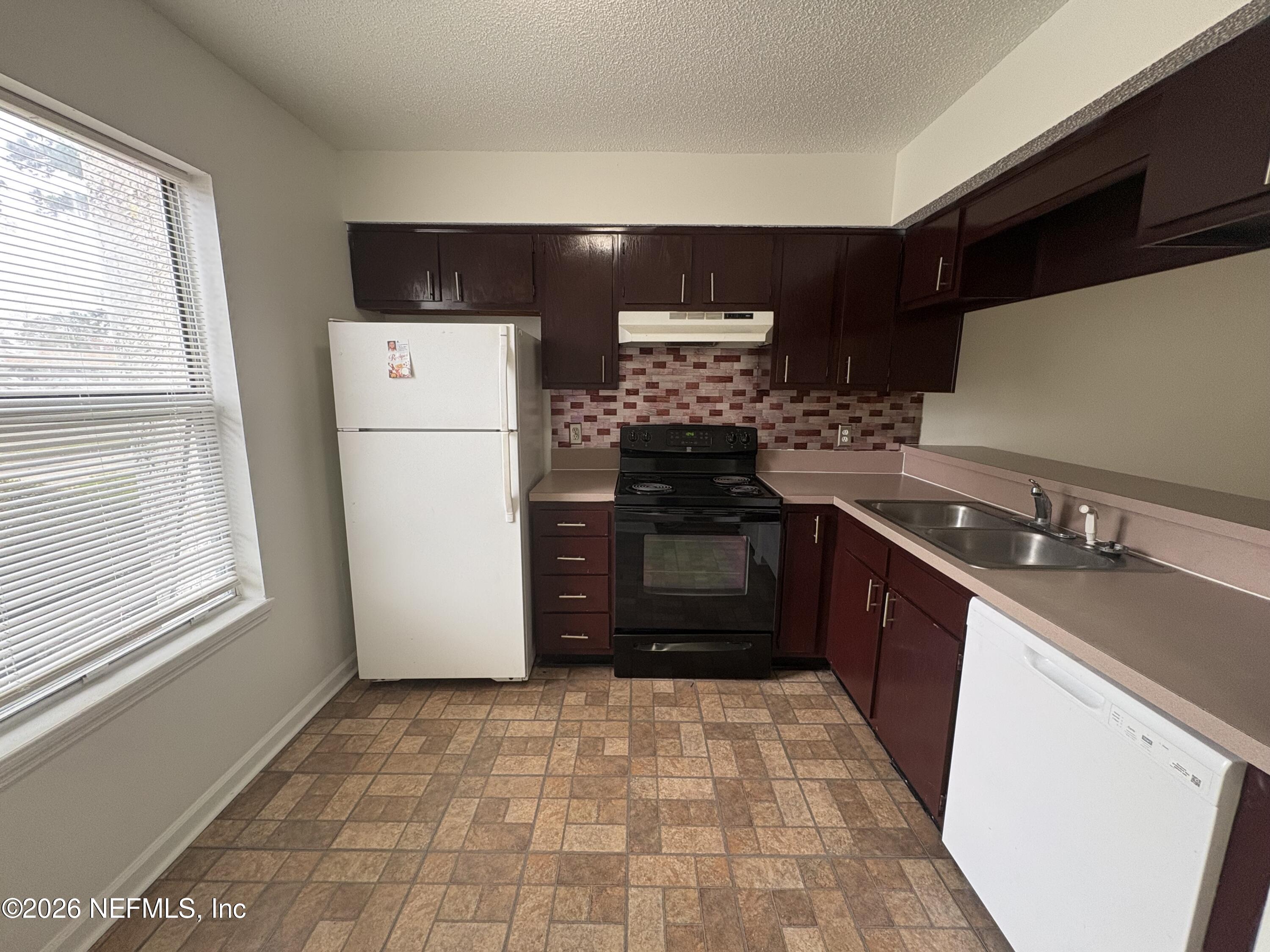 4647 Barnes Road South Jacksonville, FL 32207 - Photo 2 of 11 a kitchen with a refrigerator and a stove