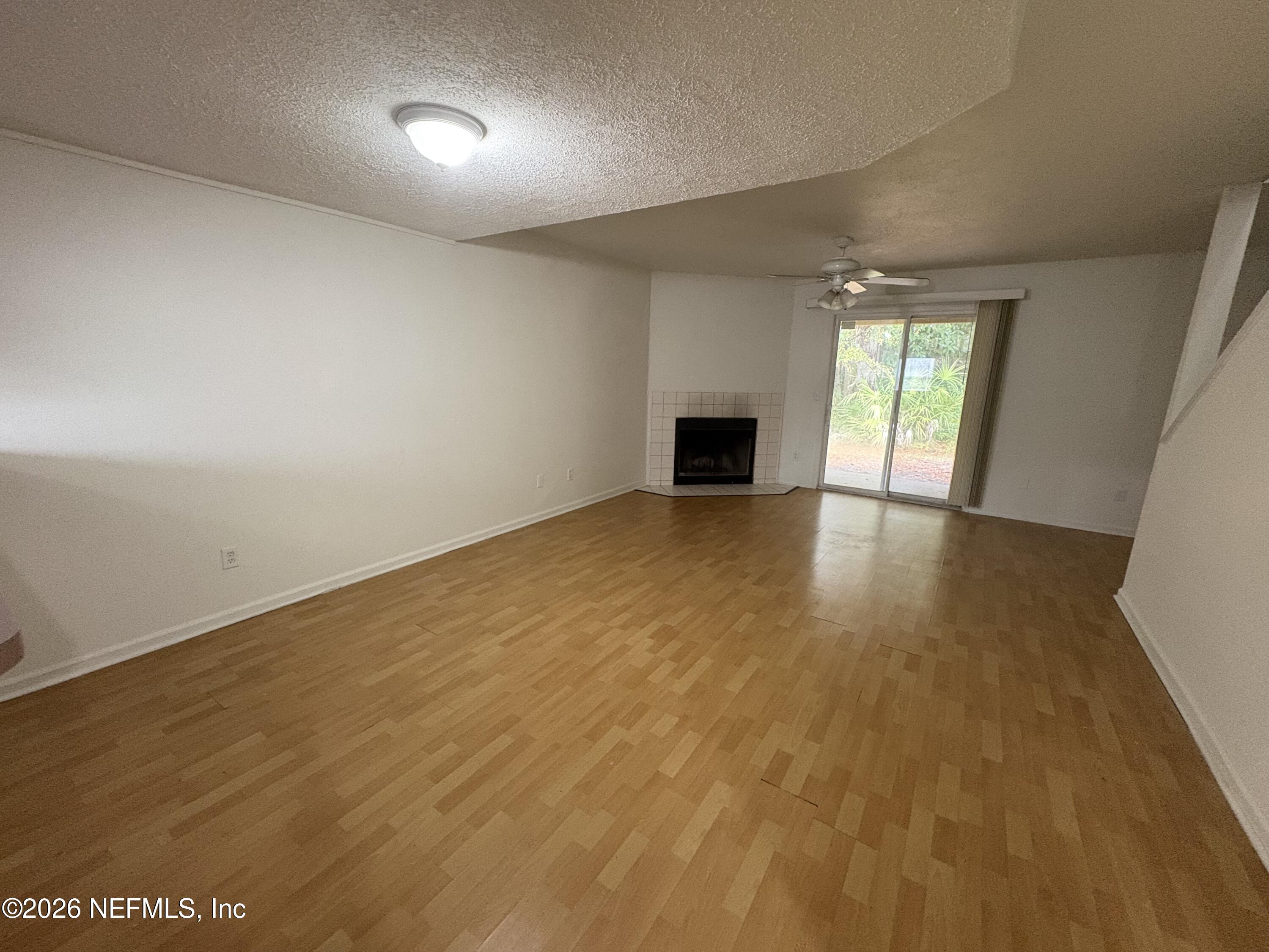 4647 Barnes Road South Jacksonville, FL 32207 - Photo 3 of 11 an empty room with windows and fireplace
