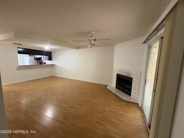 a view of empty room with a fireplace