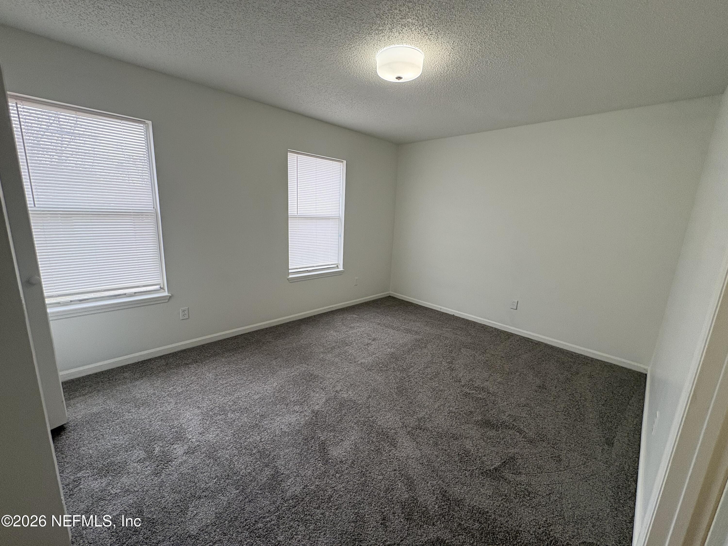 4647 Barnes Road South Jacksonville, FL 32207 - Photo 5 of 11 an empty room with windows