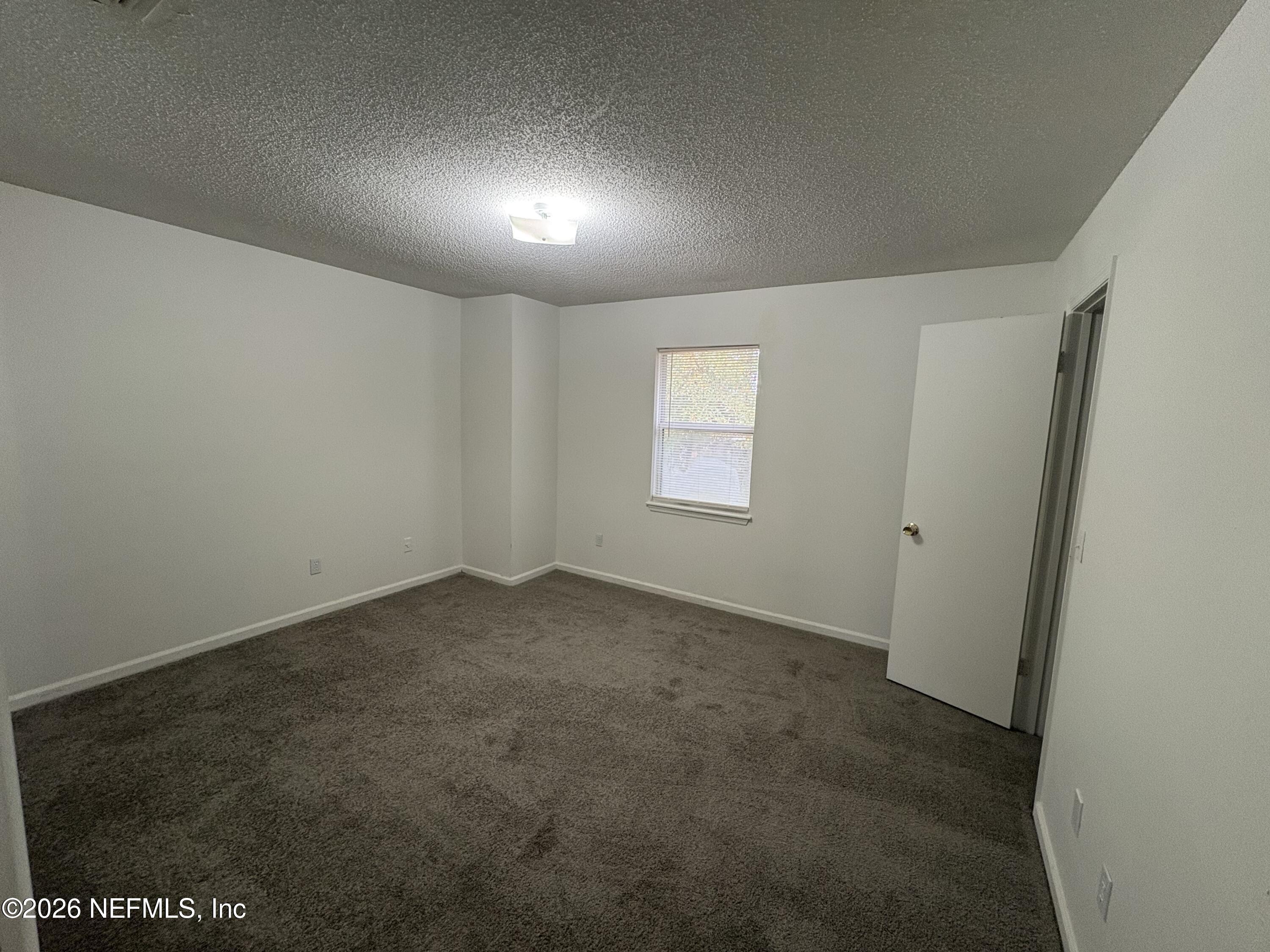 4647 Barnes Road South Jacksonville, FL 32207 - Photo 6 of 11 an empty room with windows