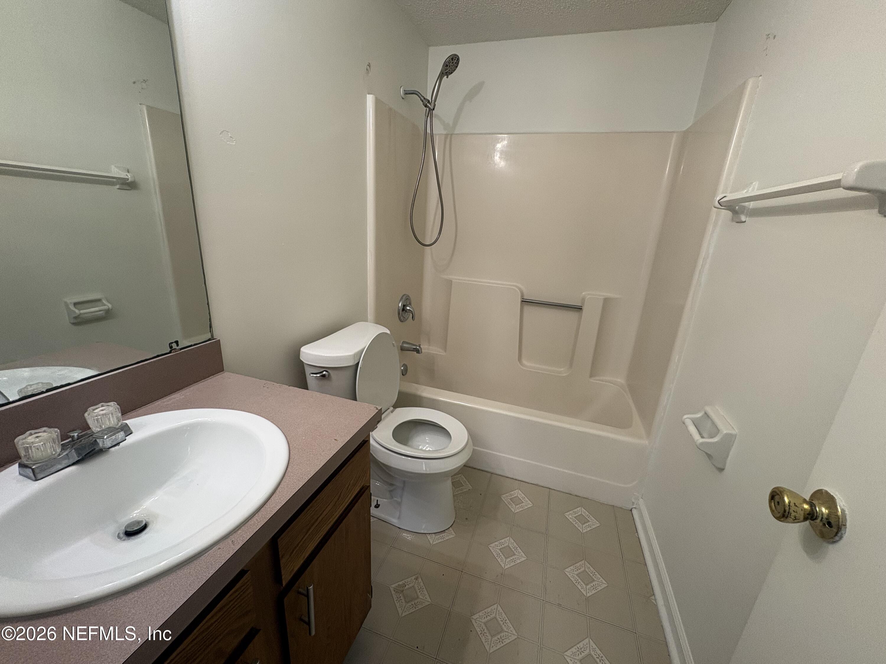 4647 Barnes Road South Jacksonville, FL 32207 - Photo 10 of 11 a bathroom with a sink a toilet and shower