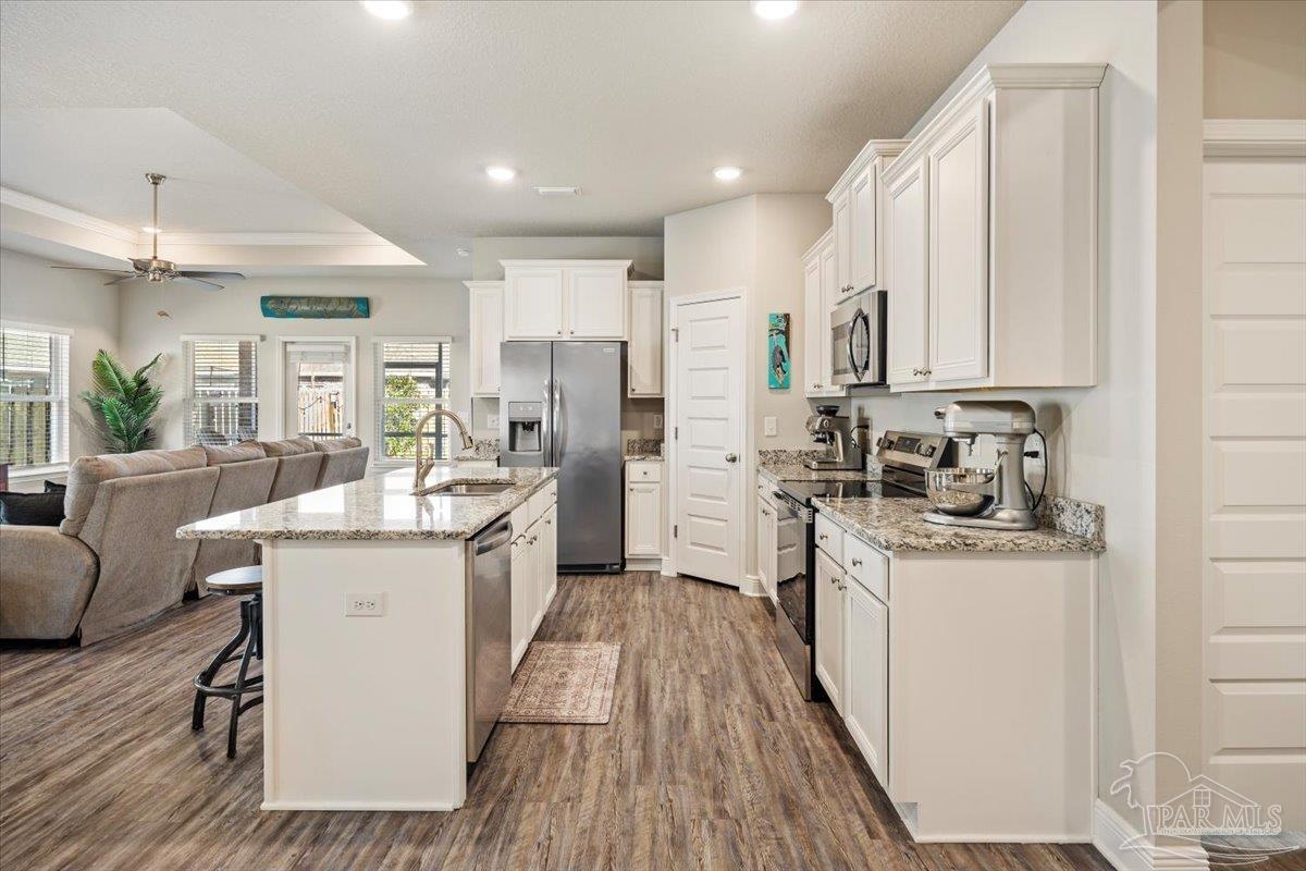 5344 Red Shoulder Road Pace, FL 32571 - Photo 11 of 28 a kitchen with a sink stove cabinets and refrigerator