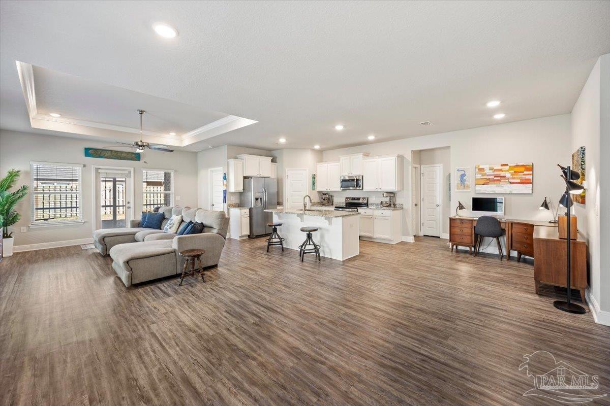 5344 Red Shoulder Road Pace, FL 32571 - Photo 12 of 28 a living room with furniture and a wooden floor