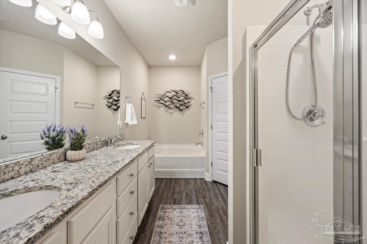 5344 Red Shoulder Road Pace, FL 32571 - Photo 18 of 28 a bathroom with a granite countertop sink a mirror and a shower
