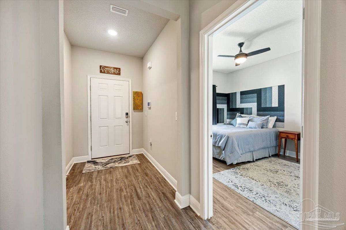 5344 Red Shoulder Road Pace, FL 32571 - Photo 3 of 28 a bedroom with a bed and a view of living room