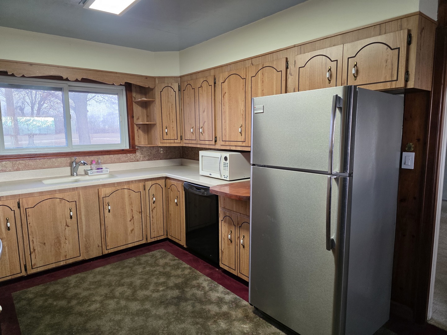 705 West Commercial Street Lyndon, IL 61261 - Photo 5 of 17 a kitchen with stainless steel appliances granite countertop a refrigerator sink and cabinets