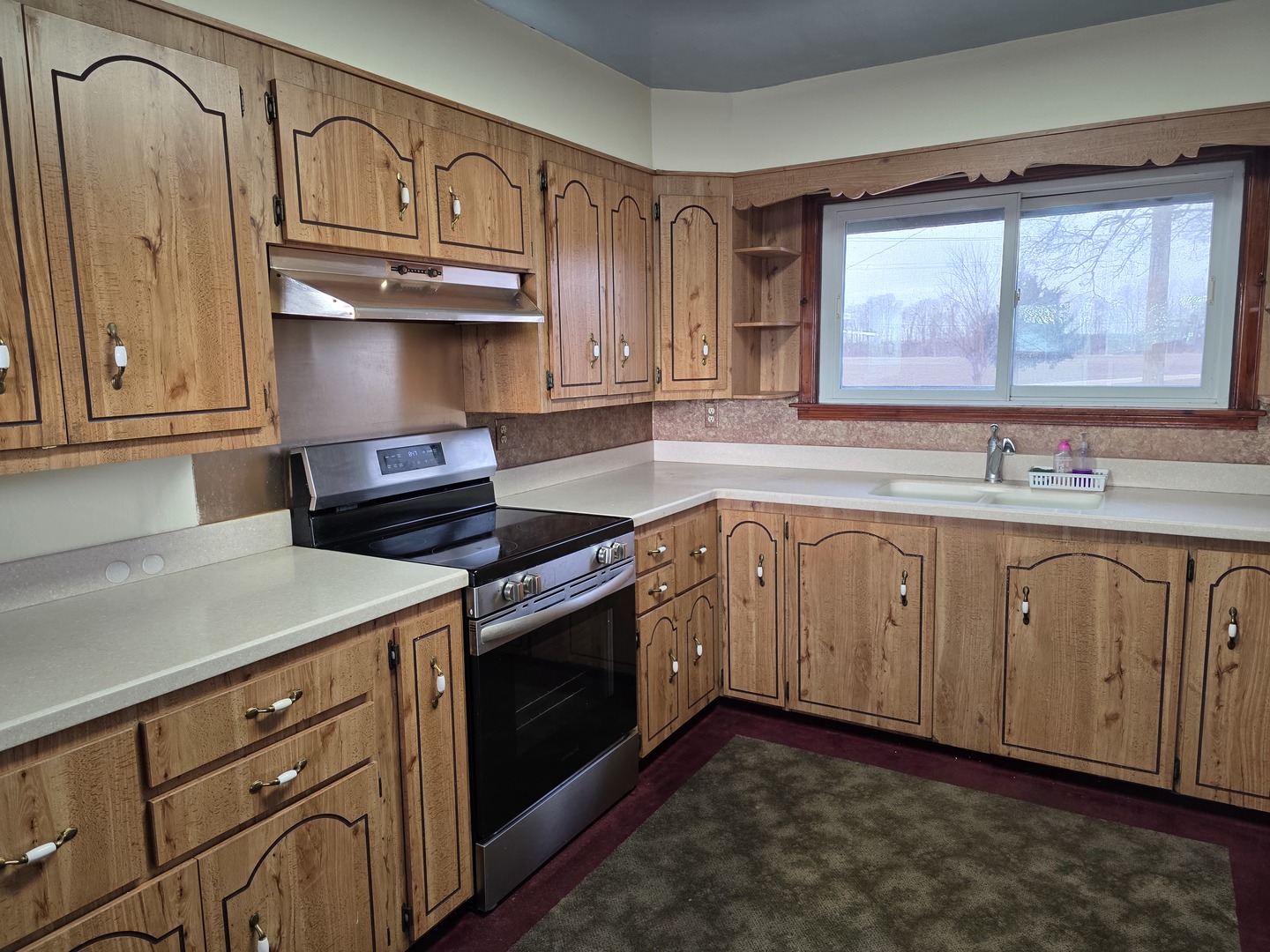 705 West Commercial Street Lyndon, IL 61261 - Photo 6 of 17 a kitchen with stainless steel appliances granite countertop a sink a stove and a microwave oven