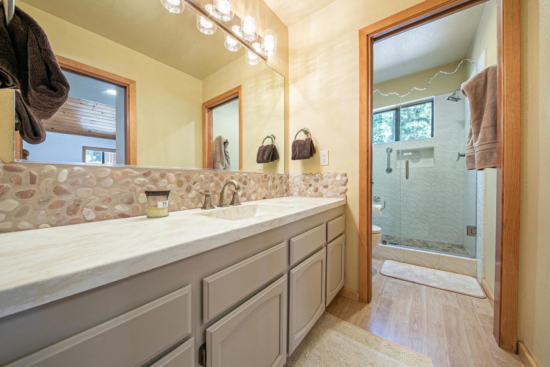 13515 Ski View Loop Truckee, CA 96161 - Photo 20 of 28 a bathroom with a granite countertop sink mirror bathtub and shower