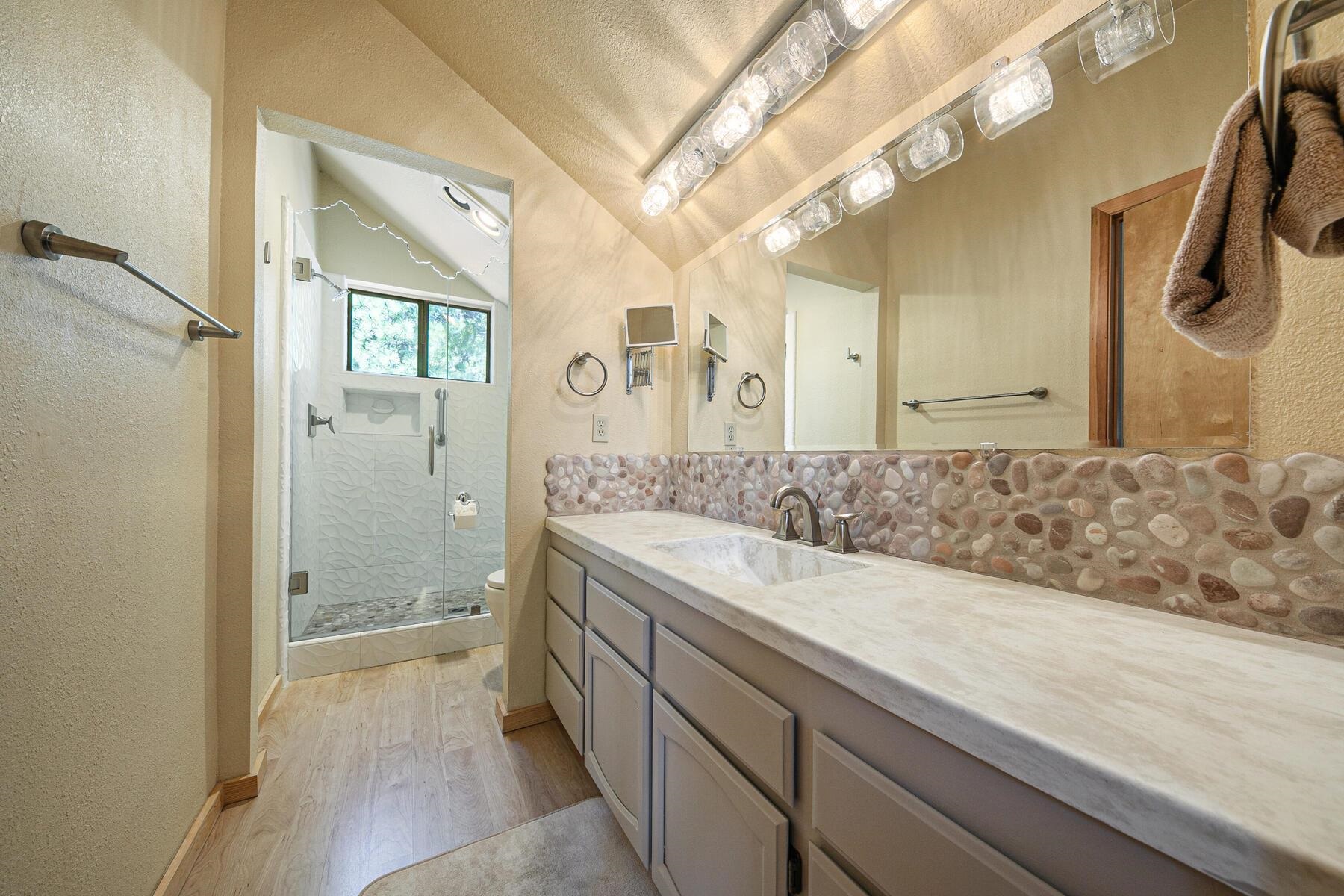 13515 Ski View Loop Truckee, CA 96161 - Photo 27 of 28 a bathroom with a sink a mirror and a shower