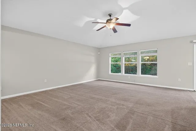 a bathroom with a granite countertop sink a toilet a mirror and bathtub