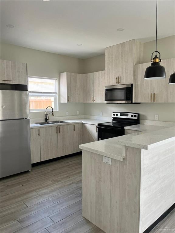 1320 North McColl Road, Unit 2 Edinburg, TX 78541 - Photo 11 of 24 a kitchen with stainless steel appliances a sink a stove a microwave a sink a refrigerator and cabinets