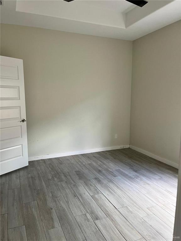 1320 North McColl Road, Unit 2 Edinburg, TX 78541 - Photo 13 of 24 a view of an empty room with wooden floor and a window