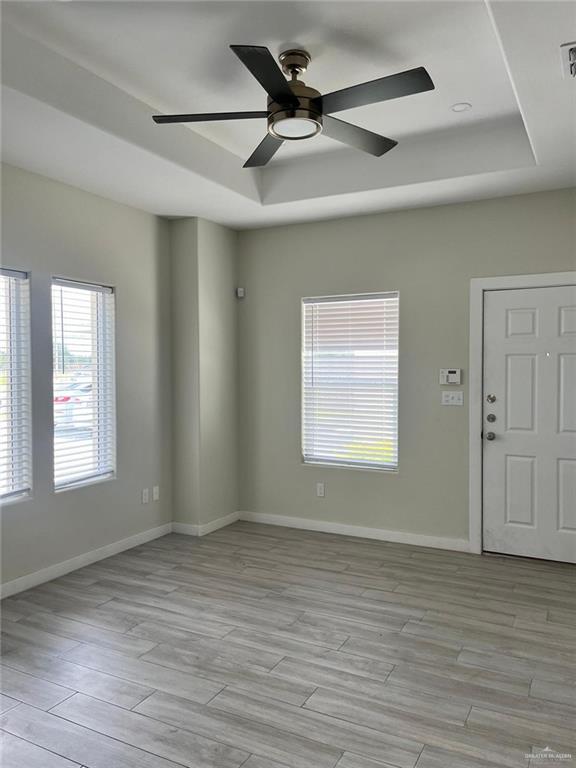 1320 North McColl Road, Unit 2 Edinburg, TX 78541 - Photo 14 of 24 a view of an empty room with wooden floor and a window