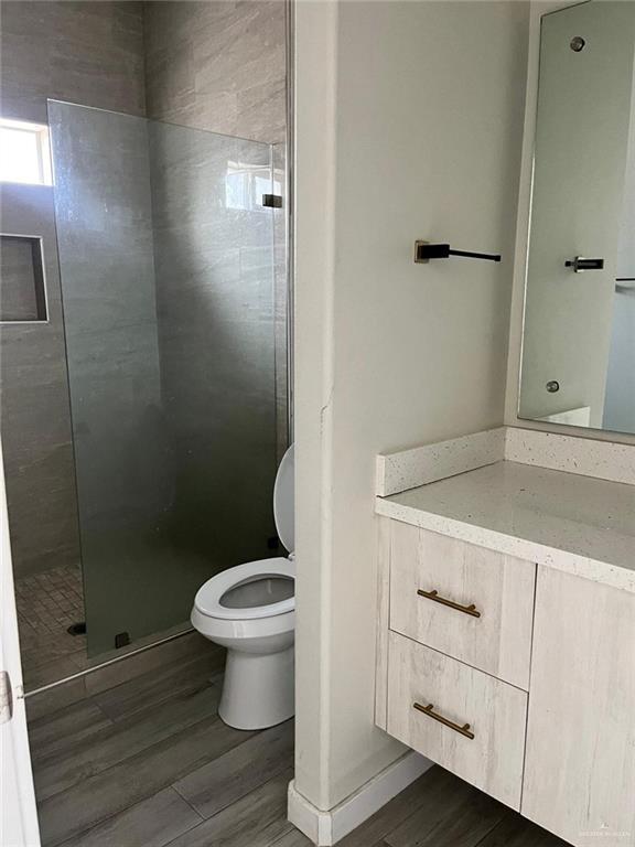 1320 North McColl Road, Unit 2 Edinburg, TX 78541 - Photo 15 of 24 a bathroom with a granite countertop toilet and a sink