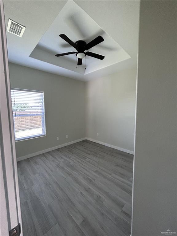 1320 North McColl Road, Unit 2 Edinburg, TX 78541 - Photo 19 of 24 an empty room with a ceiling fan and wooden floor