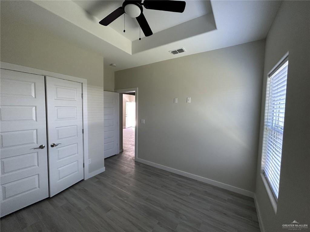 1320 North McColl Road, Unit 2 Edinburg, TX 78541 - Photo 20 of 24 an empty room with wooden floor cabinet and windows