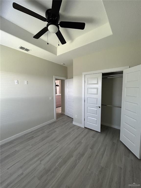 1320 North McColl Road, Unit 2 Edinburg, TX 78541 - Photo 23 of 24 a view of an empty room with wooden floor and a ceiling fan