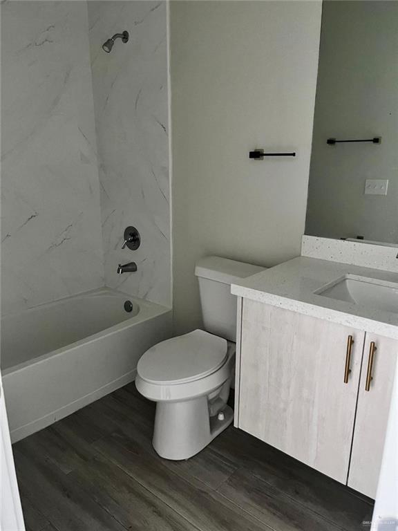 1320 North McColl Road, Unit 2 Edinburg, TX 78541 - Photo 4 of 24 a white toilet sitting next to a bathroom sink
