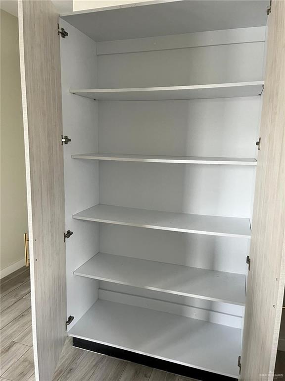 1320 North McColl Road, Unit 2 Edinburg, TX 78541 - Photo 7 of 24 a view of walk in closet with empty racks