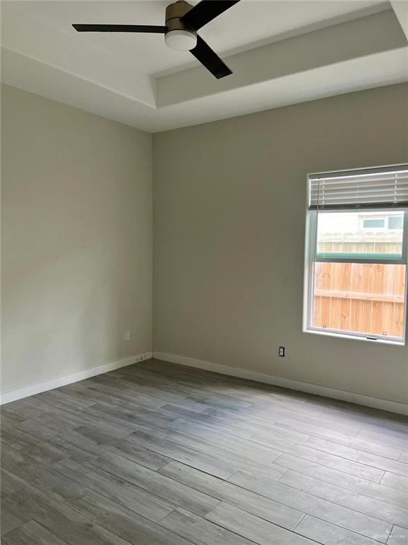 1320 North McColl Road, Unit 2 Edinburg, TX 78541 - Photo 10 of 24 an empty room with wooden floor and windows