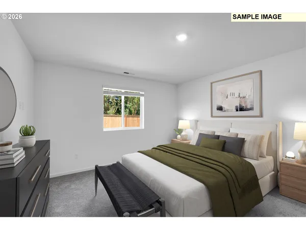 a bedroom with a bed and painting on the wall