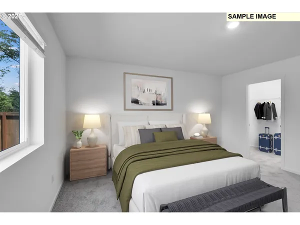 a bedroom with a bed and a large window