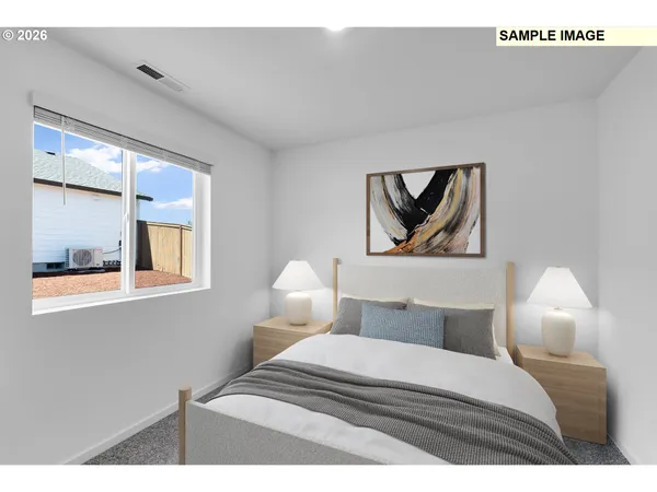 a bedroom with a bed and a painting on the wall