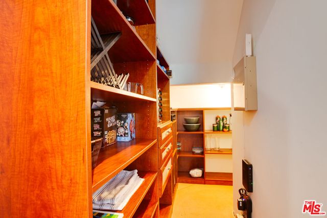 a bathroom with a granite countertop sink a toilet a mirror and a window