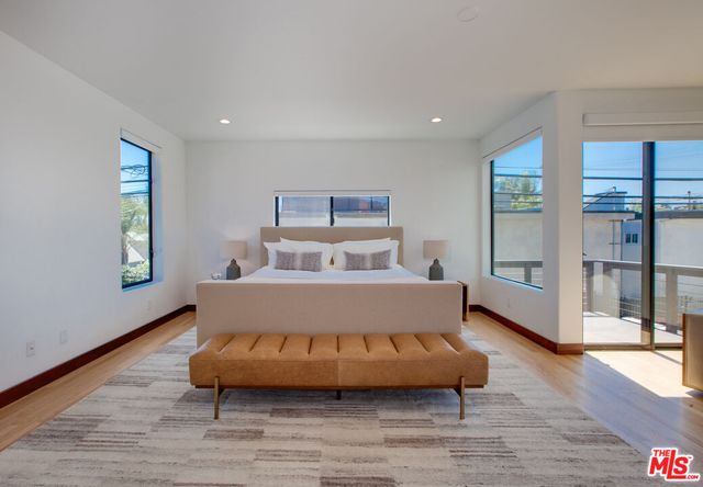 a bedroom with furniture and a large window