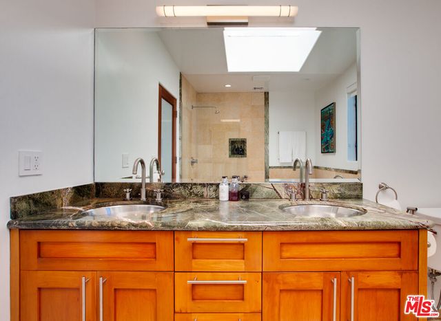 a bathroom with a tub a sink and a shower
