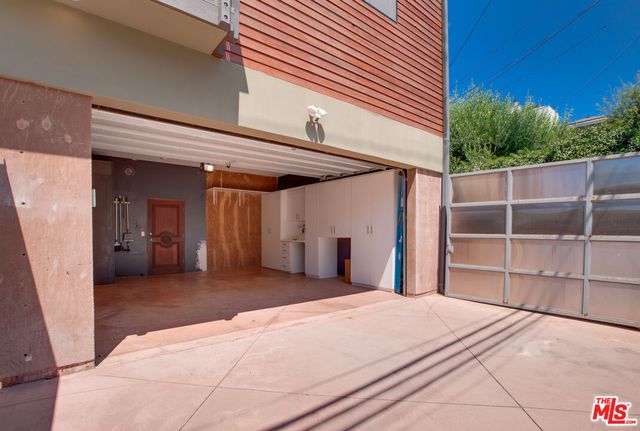 a front view of a house with plants
