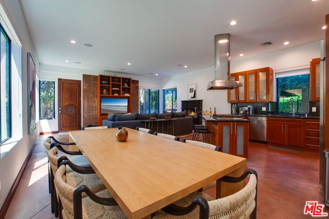 a living room with furniture a rug and a large window