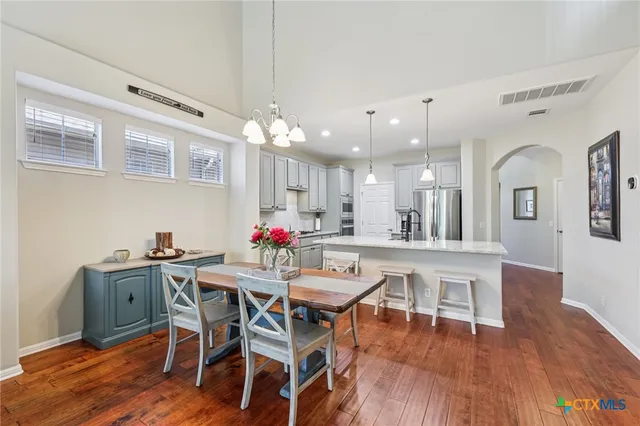 a view of a dining room with furniture and wooden floor