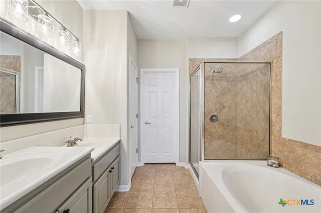 a bathroom with a granite countertop sink mirror bathtub and shower